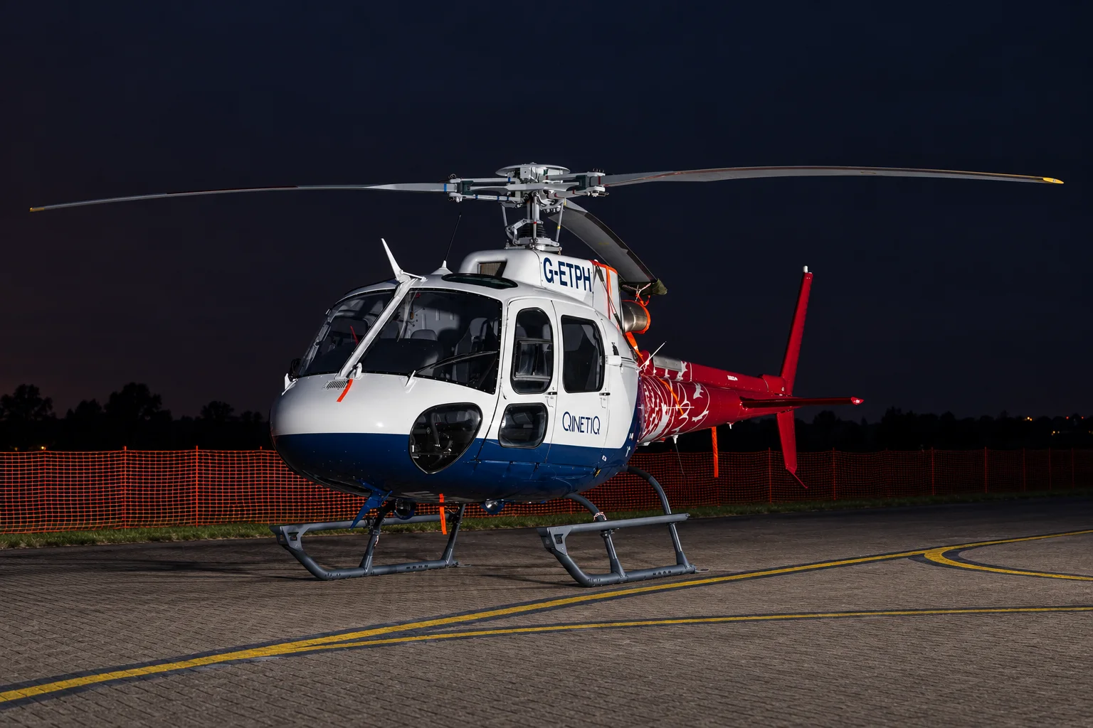 Airbus AS350 B3 helicopter prepared for flight at night