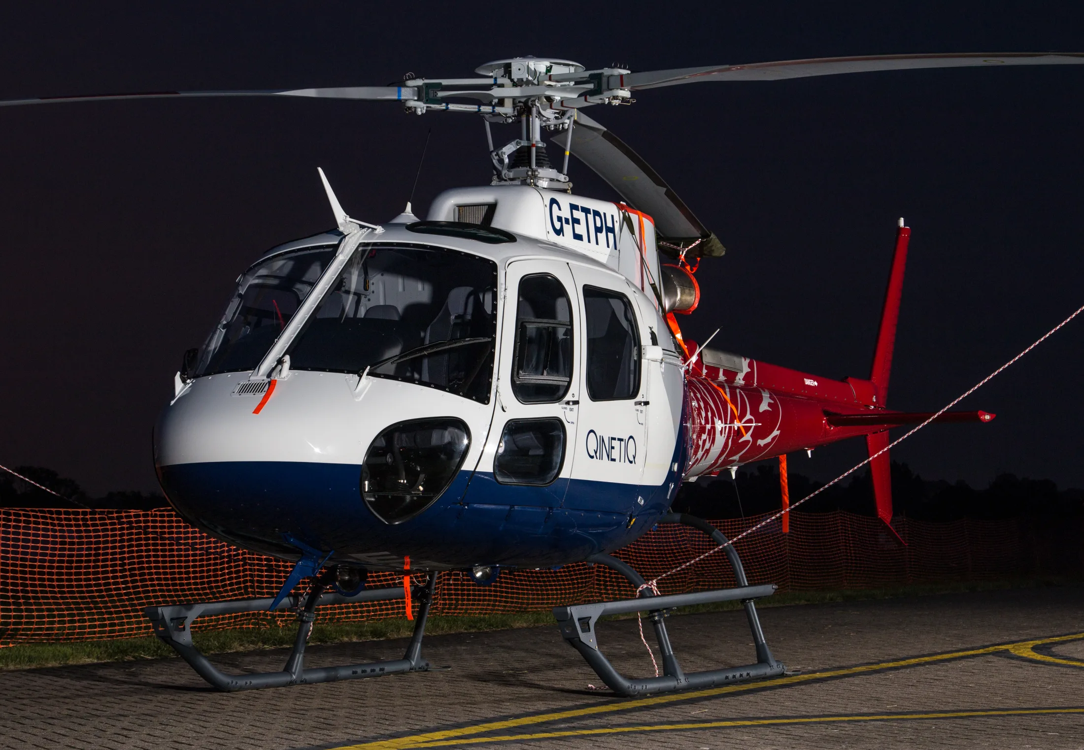 Airbus AS350 B3 helicopter prepared for flight at night