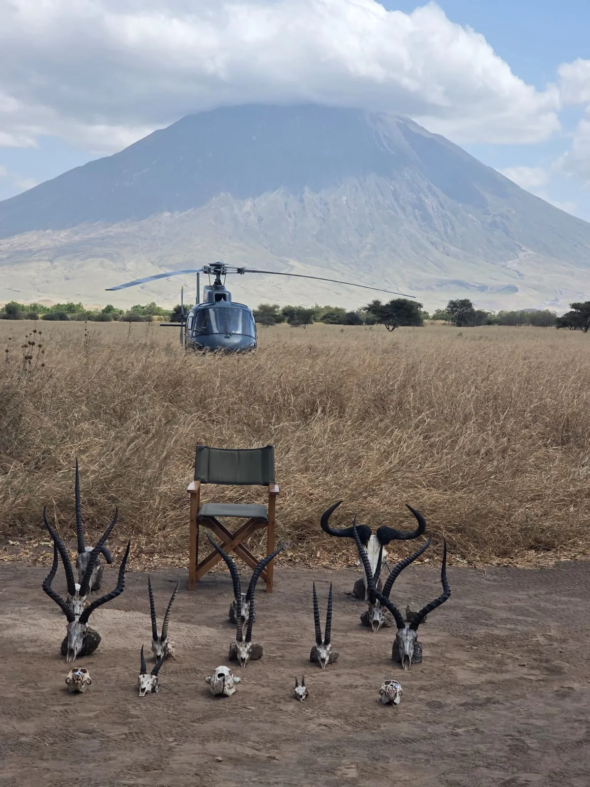 Veloxair Airbus AS350 B3 helicopter at a field camp beneath Mount Kilimanjaro